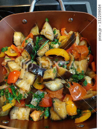 Sauteed eggplant, tomatoes, and peppers with fresh parsley in a pan healthy vegan dinner 132209084