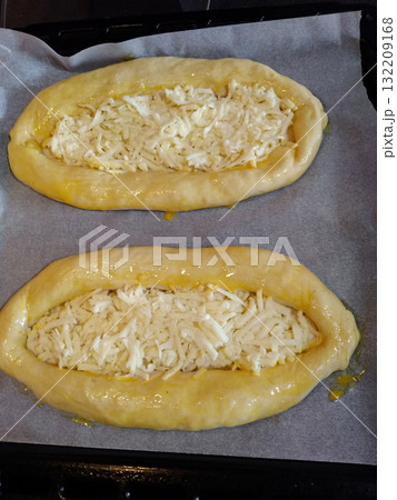 Adjarian khachapuri with sulguni cheese waiting to be baked in oven 132209168