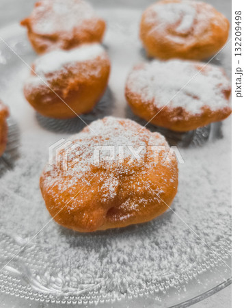 Delicious baursaki sprinkled with powdered sugar on glass plate in prague Delicious baursaki sprinkled with powdered sugar on glass plate in prague 132209498