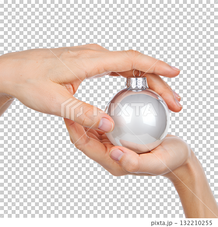 Two hands gently holding reflective silver christmas ornament, festive holiday detail isolated on transparent background Two hands gently holding reflective silver christmas ornament, festive holiday detail isolated on transparent background 132210255