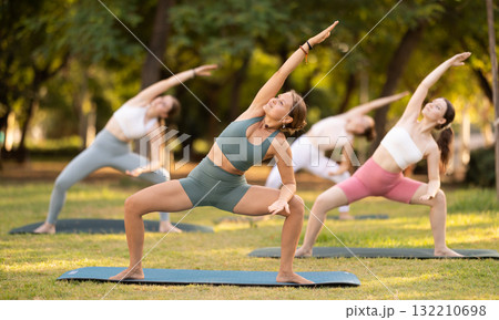Group of young women doing yoga in park Group of young women doing yoga in park 132210698