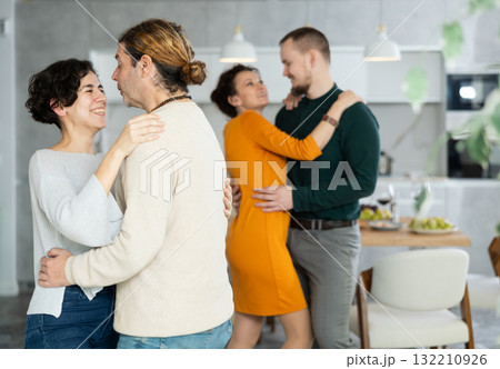 Men and women dancing during house party. Men and women dancing during house party. 132210926