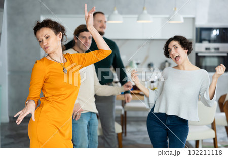 Men and women doing couple dancing during house party. Men and women doing couple dancing during house party. 132211118