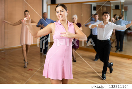 Young woman practicing ballroom dance pose in dance studio Young woman practicing ballroom dance pose in dance studio 132211194