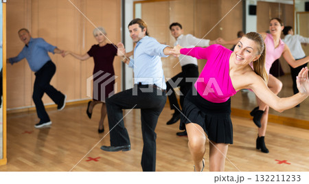 Middle-aged pair practicing Latino dance in dance studio 132211233