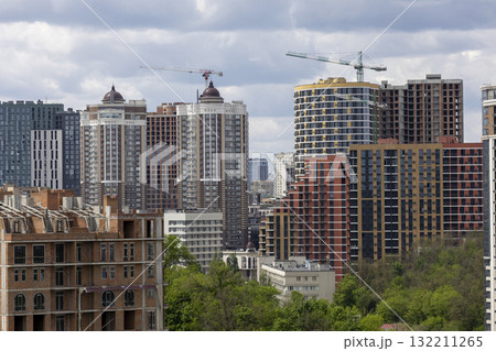 Urban High-Rise Construction with Tower Crane and Modern Apartments Urban High-Rise Construction with Tower Crane and Modern Apartments 132211265