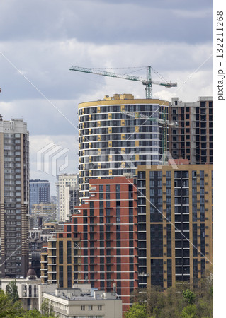 Urban High-Rise Construction with Tower Crane and Modern Apartments Urban High-Rise Construction with Tower Crane and Modern Apartments 132211268