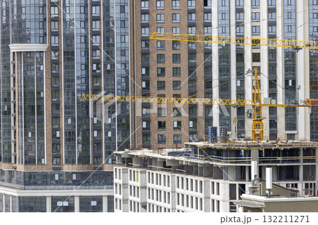 Urban High-Rise Construction with Tower Crane and Modern Apartments 132211271