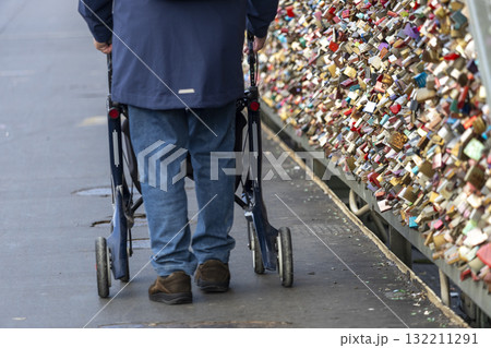 a man with rollators walk across the Hohenzollern Bridge, Cologne a man with rollators walk across the Hohenzollern Bridge, Cologne 132211291