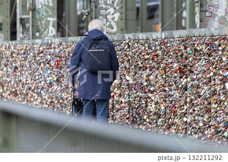 a man with rollators walk across the Hohenzollern Bridge, Cologne 132211292