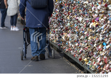 a man with rollators walk across the Hohenzollern Bridge, Cologne 132211293