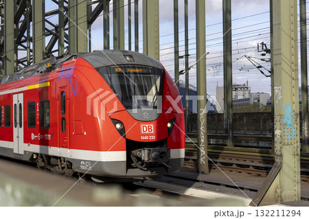 The train moves to the Cologne central station near the Hohenzollern bridge 132211294