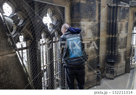 A man looks out from the observation deck of Cologne Cathedral A man looks out from the observation deck of Cologne Cathedral 132211314