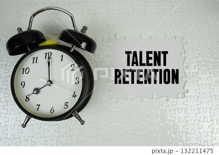 Jigsaw puzzle with a missing piece with "Talent Retention" and alarm clock on white background Jigsaw puzzle with a missing piece with "Talent Retention" and alarm clock on white background 132211475