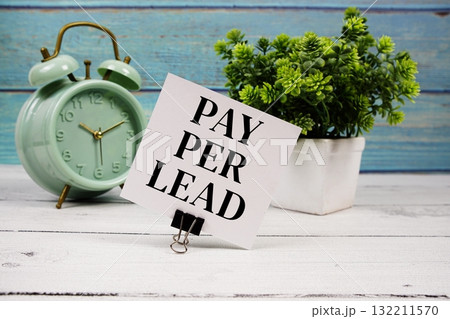 Pay Per Lead text written on paper card with alarm clock on wooden background Pay Per Lead text written on paper card with alarm clock on wooden background 132211570