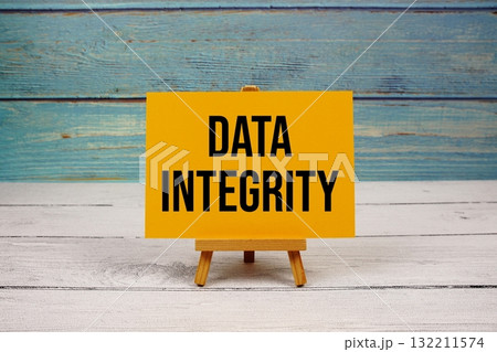 Data Integrity text written on paper card on wooden background Data Integrity text written on paper card on wooden background 132211574