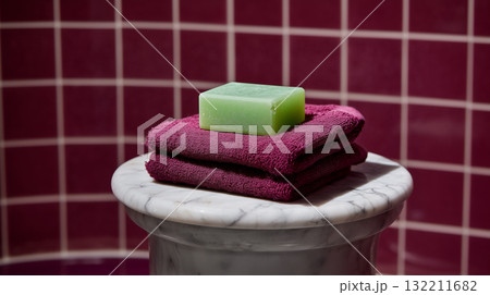 Green Soap Bar and Towels on Marble Stand Representing Self Care and Clean Living 132211682