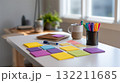 Organized Home Office Desk with Colorful Sticky Notes and Stationery in Natural Light 132211685
