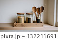 Minimalist Kitchen Decor with Wooden Utensils and Glass Jars in Natural Light 132211691