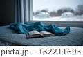 Cozy Winter Morning with Open Book and Soft Blanket by the Window 132211693