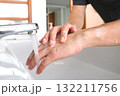 Hands of woman wash their hands in a sink with foam to wash the skin and water flows through the hands. Concept of health, cleaning and preventing germs and coronavirus from contacting hands 132211756