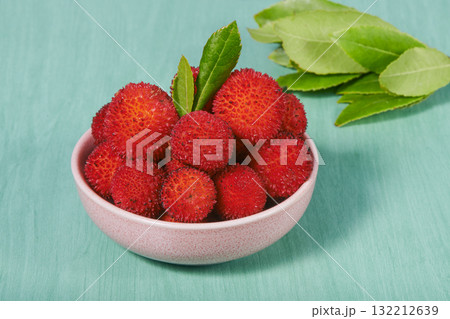 arbutus berries in a small pink bowl on turquoise arbutus berries in a small pink bowl on turquoise 132212639