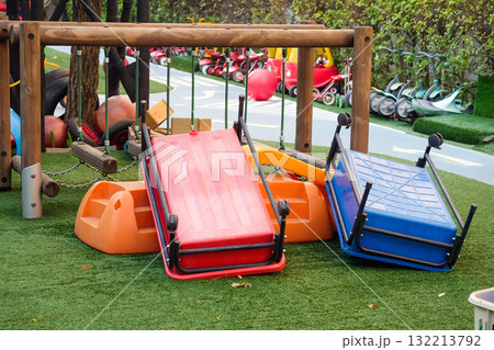 Empty playground with various equipment and toys on green synthetic grass 132213792