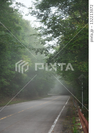 霧がかかる秋の山間の車道 132213872
