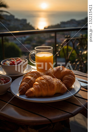 cup of coffee and french croissant on table, balcony with view of beautiful landscape, still life, sea and mountains, resort town, sunset cup of coffee and french croissant on table, balcony with view of beautiful landscape, still life, sea and mountains, resort town, sunset 132215421
