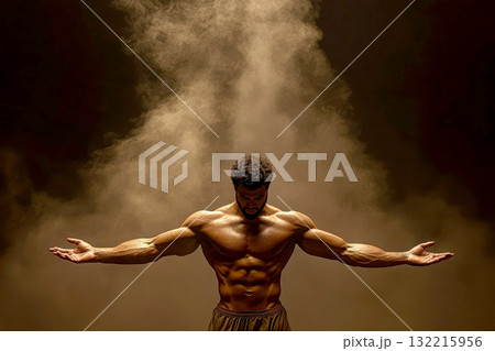 A muscular man poses triumphantly amidst dramatic lighting. A muscular man poses triumphantly amidst dramatic lighting. 132215956