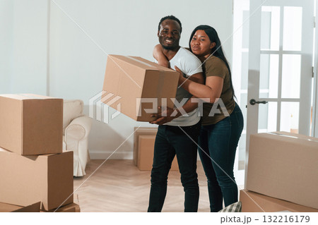 Holding boxes. African American couple are moving into new house Holding boxes. African American couple are moving into new house 132216179