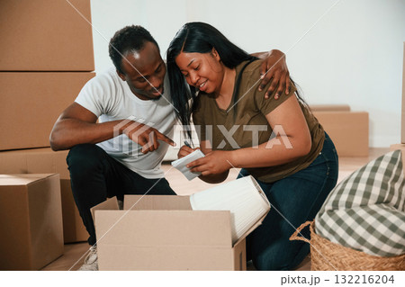 Cheerful people. African American couple are moving into new house 132216204