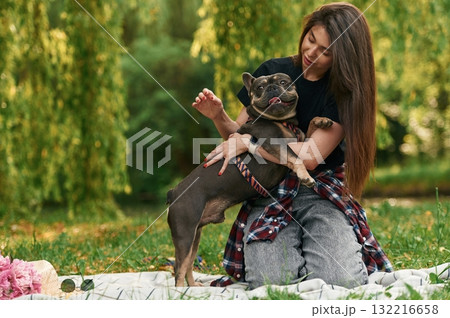 Weekend activities. Young pretty woman is with her dog in the park 132216658