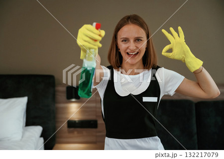 Surface cleaning conception. Young chambermaid is in hotel room 132217079