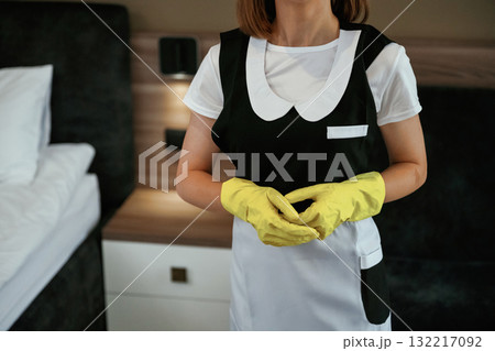 Young chambermaid is in hotel room 132217092