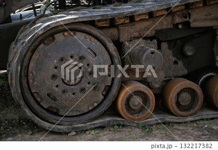 Close-up of old rusty tank tracks with dirt and grime Close-up of old rusty tank tracks with dirt and grime 132217382
