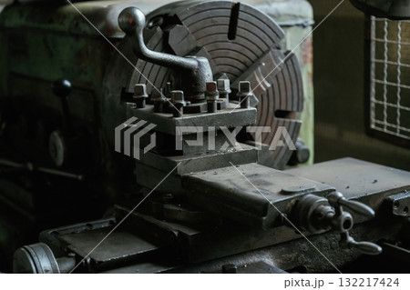 Vintage industrial lathe in an old workshop setting 132217424