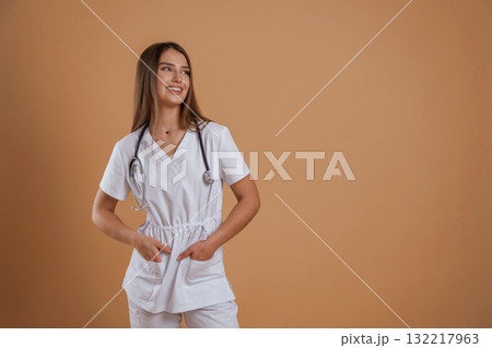 Joyful facial expression from a nurse. Young pretty woman is against background in the studio 132217963