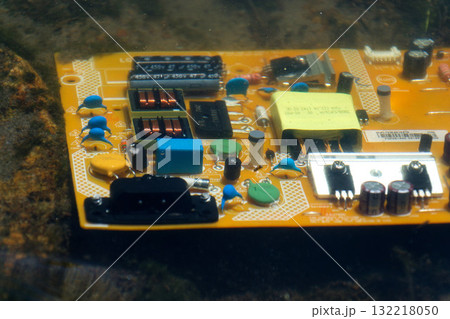 Computer motherboard submerged below water surface, cooling and energy consumption by artificial intelligence concept, environmental impacts Computer motherboard submerged below water surface, cooling and energy consumption by artificial intelligence concept, environmental impacts 132218050
