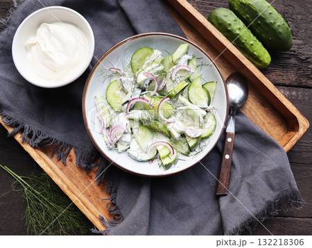 Cucumber with red onion and dill salad in yogurt dressing	 132218306