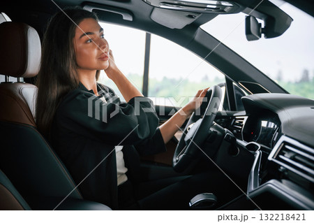 View from the side. Beautiful businesswoman is in the new car 132218421