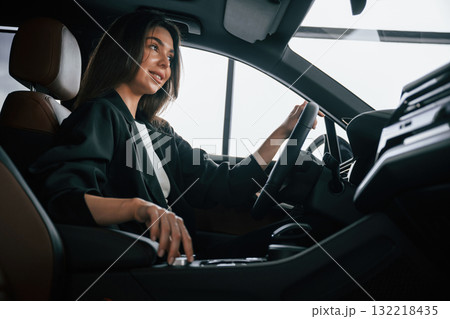 Turning the knob. Beautiful businesswoman is in the new car 132218435