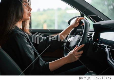 Enjoying the ride. Beautiful businesswoman is in the new car Enjoying the ride. Beautiful businesswoman is in the new car 132218475