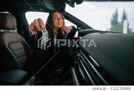 Cheerful, happy new owner with keys. Beautiful businesswoman is in the new car 132218489