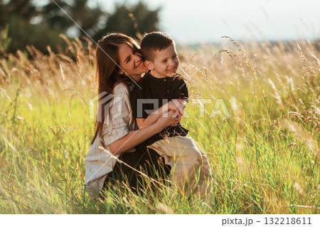 On the agricultural field. Mother with son are together On the agricultural field. Mother with son are together 132218611