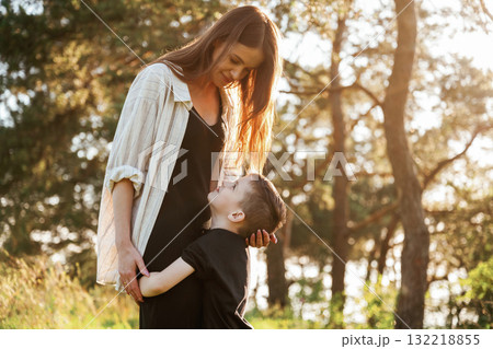 Embracing each other. Mother and son are in the forest together Embracing each other. Mother and son are in the forest together 132218855
