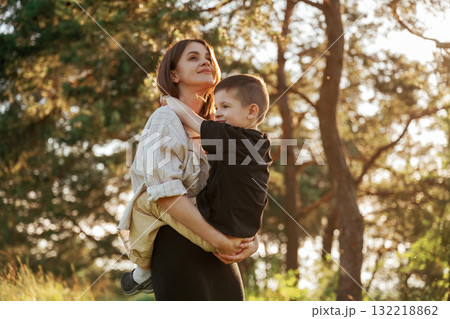 Enjoying the time together. Mother and son are in the forest 132218862
