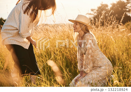 Two women friends are in the rural field Two women friends are in the rural field 132218924