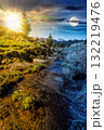 rural scene of mountain landscape on spring equinox. day and night time change concept. green countryside with forested hills with sun and moon at twilight 132219476