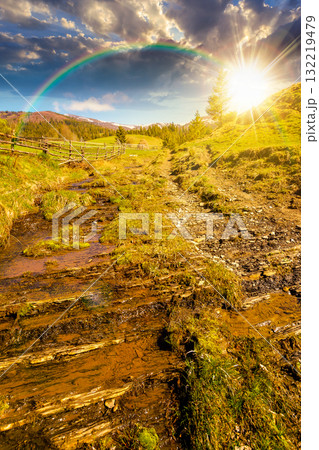 rural scene of mountain landscape in spring at sunset. green countryside with forested hills in evening light. beautiful valley sustainable development under rainbow rural scene of mountain landscape in spring at sunset. green countryside with forested hills in evening light. beautiful valley sustainable development under rainbow 132219479